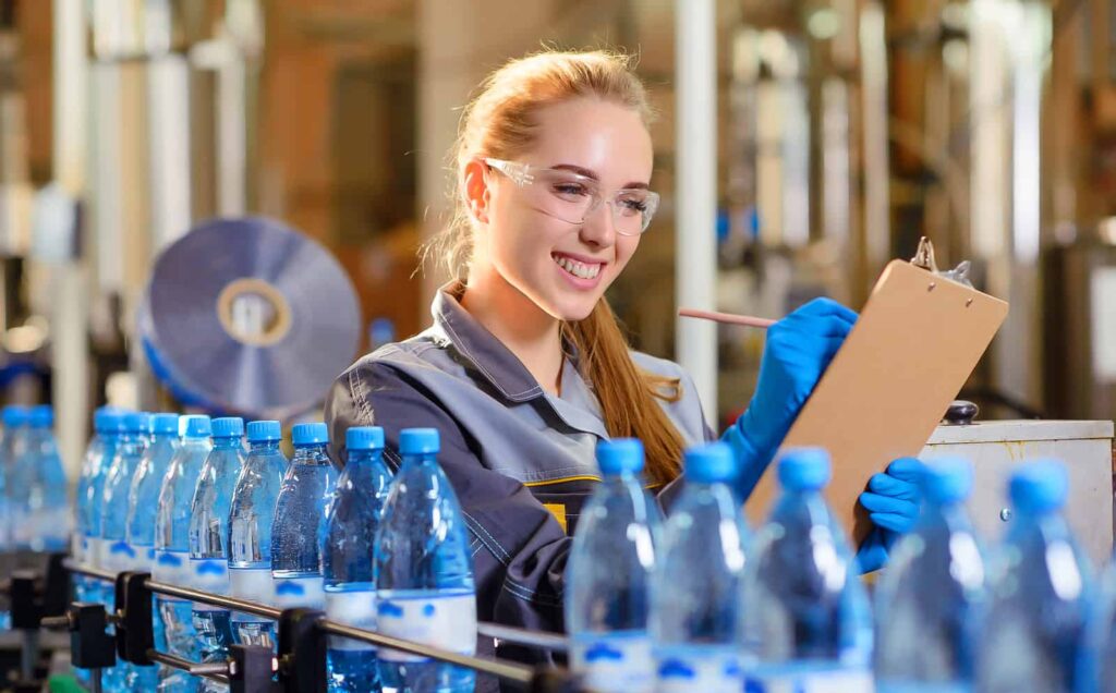 A worker records notes in her equipment maintenance log.