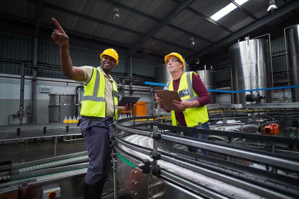 Two inspectors conduct a food processing facility assessment.