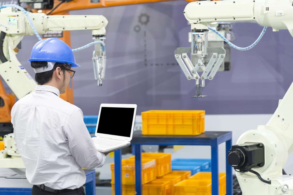 An engineer watches as technology automates the process of one of his machines at the food processing plant he works at.