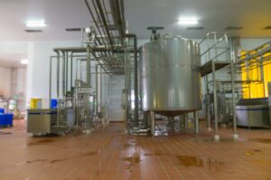 A recently cleaned milk pasteurization machine in a food processing plant.